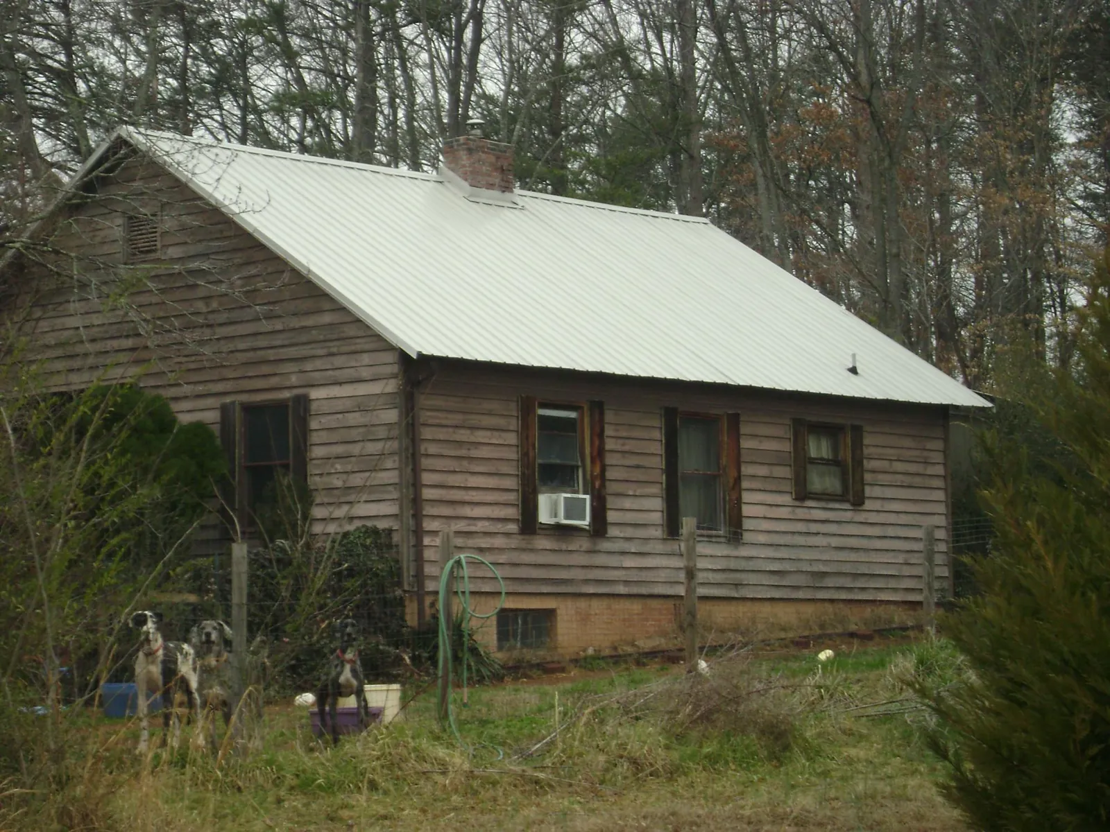 White metal roof on an old wood sided farmhouse, from a Metal Roof Installation job in Pillager